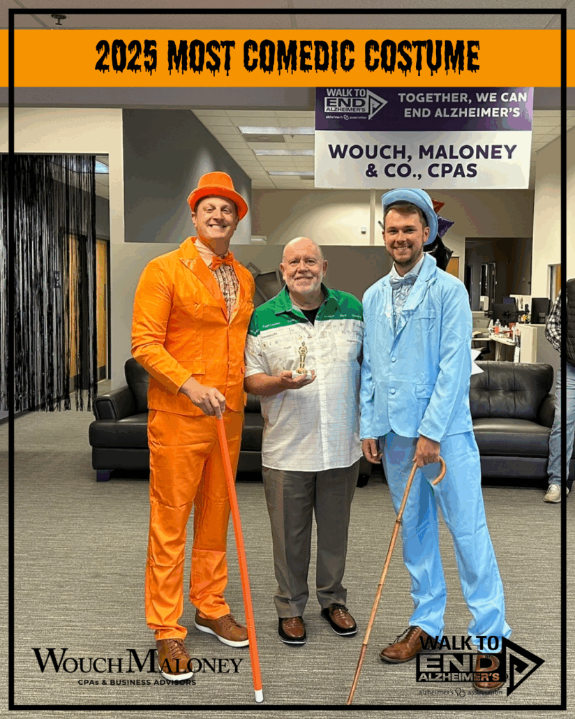 A man in an orange suit and a man in a blue suit receiving a trophy.
