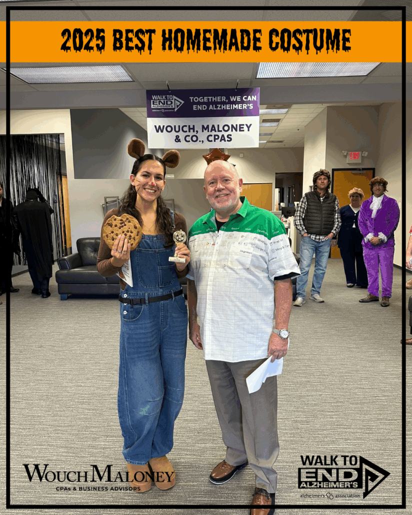 Woman dressed as a mouse holding a cookie with a man presenting a trophy.