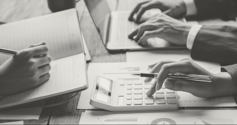 Hands on calculator and laptop keyboard